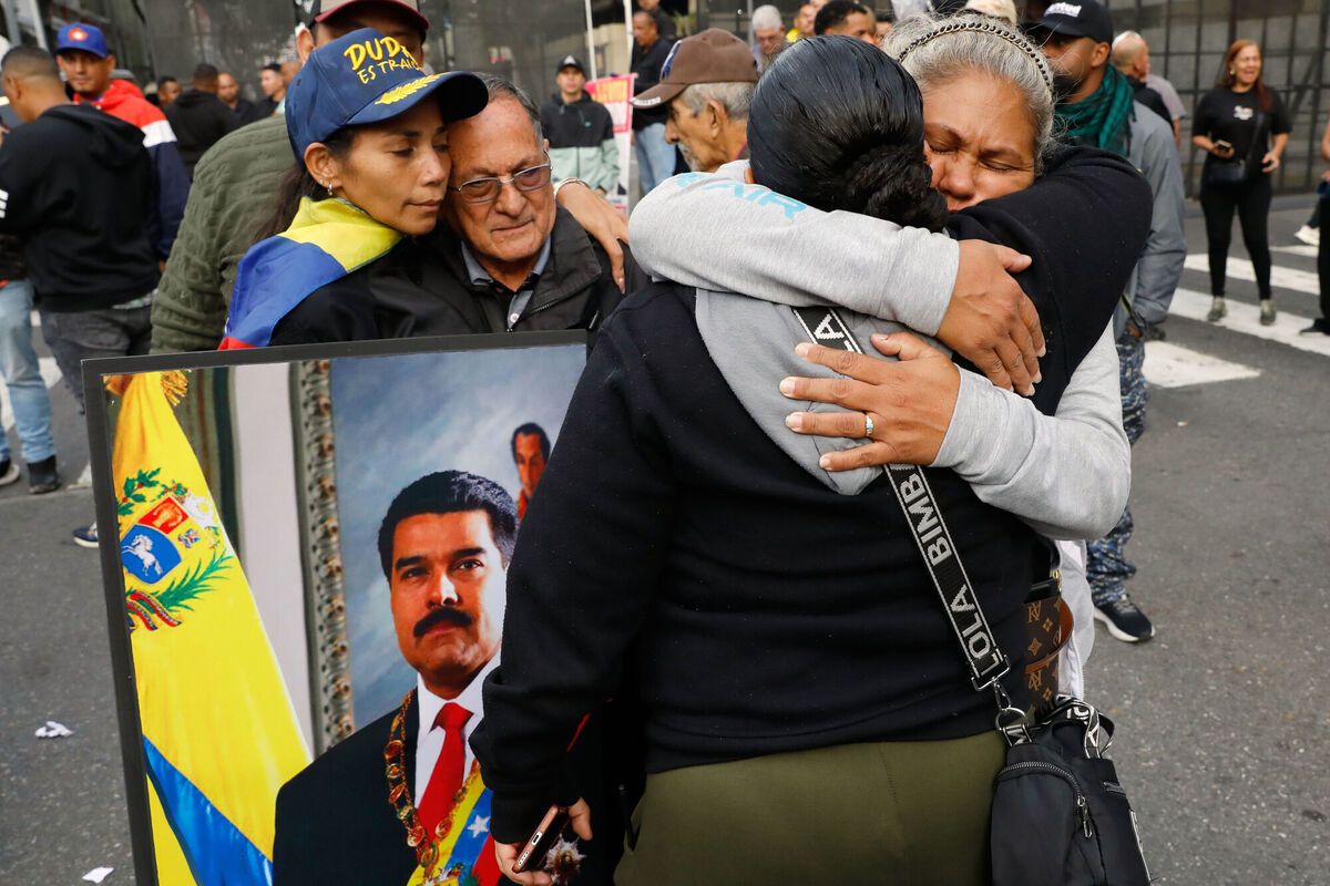 Supporters of Venezuelan President Nicolás Maduro embrace in downtown Caracas, Venezuela, Saturday, Jan. 3, 2026, after U.S. President Donald Trump announced that Maduro had been captured and flown out of the country. (AP Photo/Cristian Hernandez) Supporters of Venezuelan President Nicolás Maduro embrace in downtown Caracas, Venezuela, Saturday, Jan. 3, 2026, after U.S. President Donald Trump announced that Maduro had been captured and flown out of the country. (AP Photo/Cristian Hernandez)