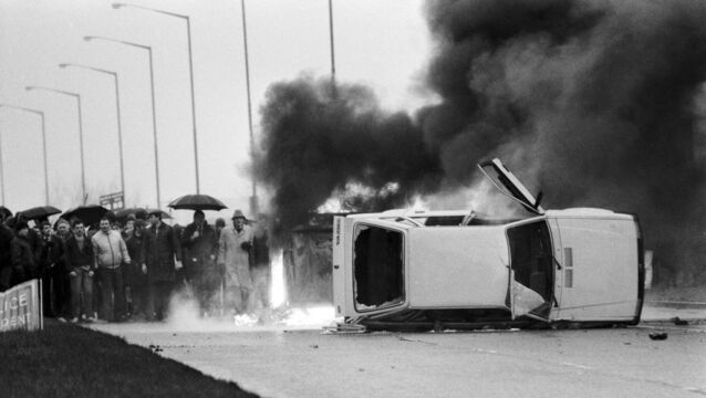 <p>A police vehicle overturned and set alight by a Loyalist mob near Belfast on Saturday, January 4, 1986 — one of a string of protests against the Anglo-Irish Agreement. Violence continued unabated in the North, with 61 people losing their lives. Picture: Bryn Colton/Getty </p>