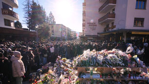 People gather during a memorial procession in Crans-Montana (Antonio Calanni/AP)