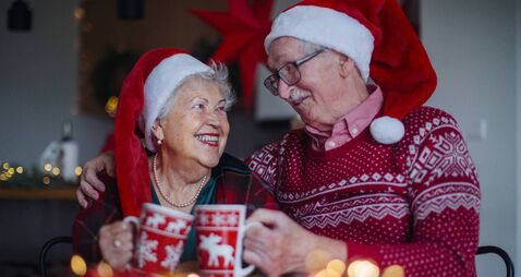 Happy senior couple celebrating Christmas Eve together.