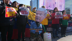 <p>A man in a Trump mask gestures during a protest in Seoul, South Korea, after the US captured Venezuelan president Nicolás Maduro last weekend. Picture: Lee Jin-man/AP</p>