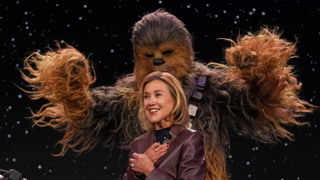 Lego chief product and marketing officer and executive vice president Julia Goldin talks as a a Chewbacca stands behind her (Abbie Parr/AP)