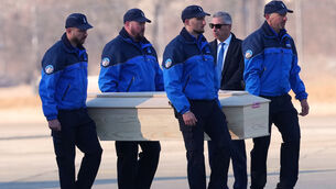 Police officers carry a coffin with the body of a blaze victim (Antonio Calanni/AP)