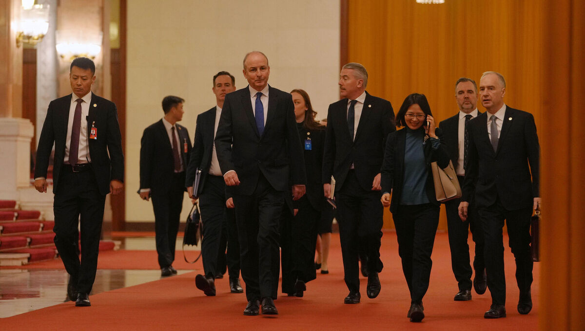 Taoiseach Micheál Martin, centre, arrives at the Great Hall of the People to meet with Chinese president Xi Jinping on Monday. Picture: Andy Wong/AP