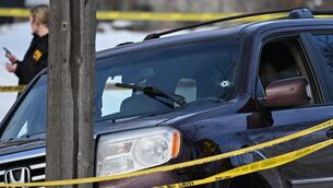 A bullet hole is seen in the windscreen of a crashed car as law enforcement officers work at the scene of the shooting (Tom Baker/AP Photo) A bullet hole is seen in the windscreen of a crashed car as law enforcement officers work at the scene of the shooting (Tom Baker/AP Photo)