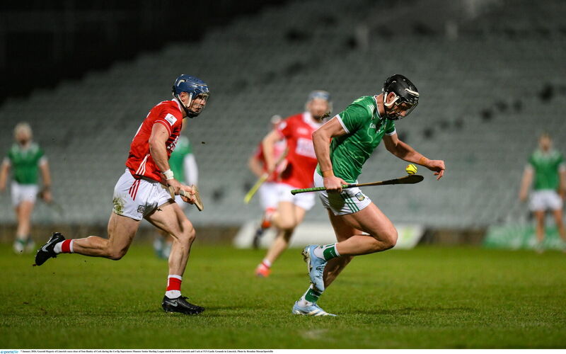 Gearoid Hegarty races clear of Tom Hanley. Pic: Brendan Moran/Sportsfile