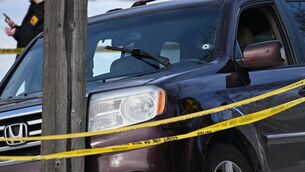 <p>A bullet hole is seen in the windscreen of a crashed car as law enforcement officers work at the scene of the shooting. Picture: Tom Baker/AP Photo</p>