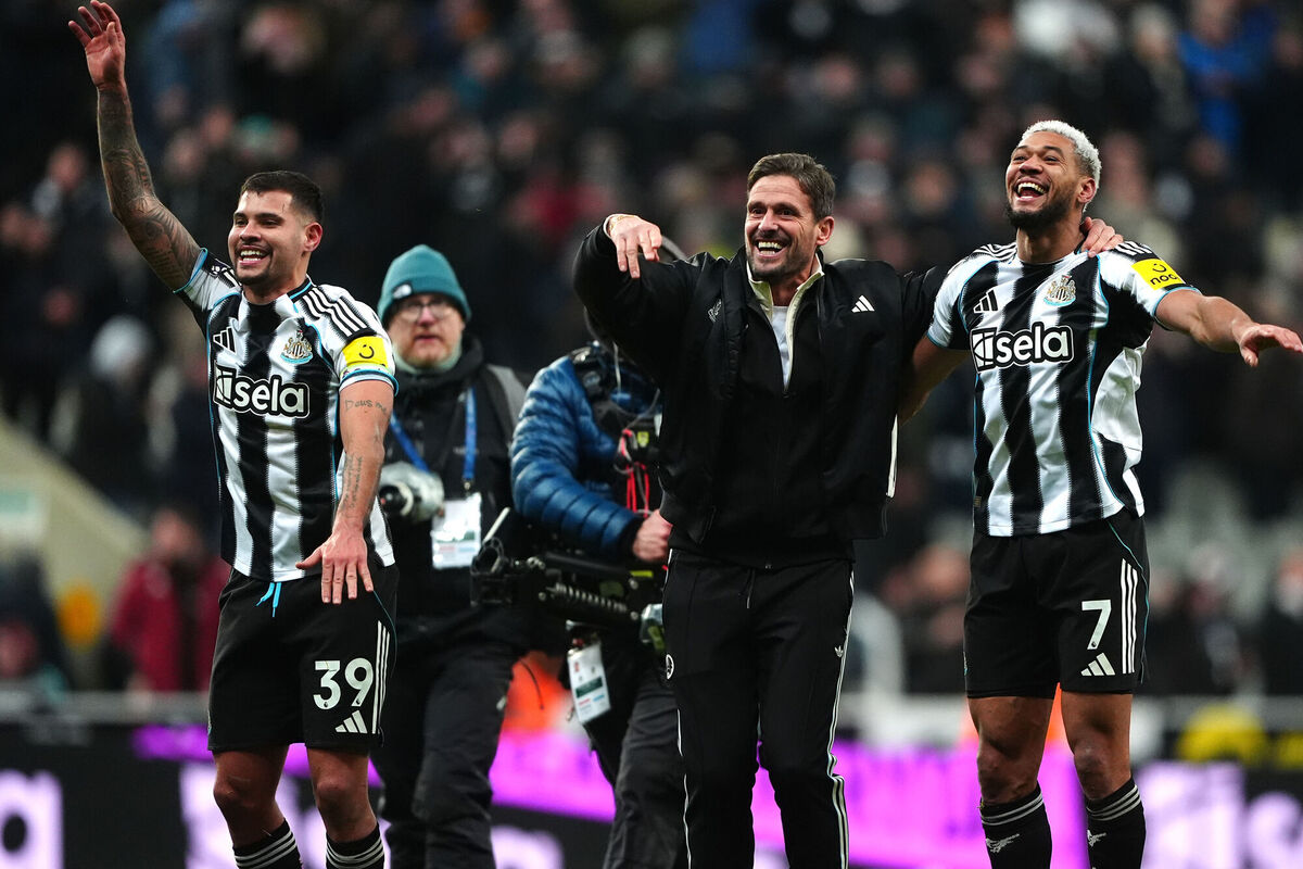 Newcastle United's Bruno Guimaraes (left) and Joelinton celebrate with assistant manager Jason Tindall (centre) following victory. Pic: Owen Humphreys/PA