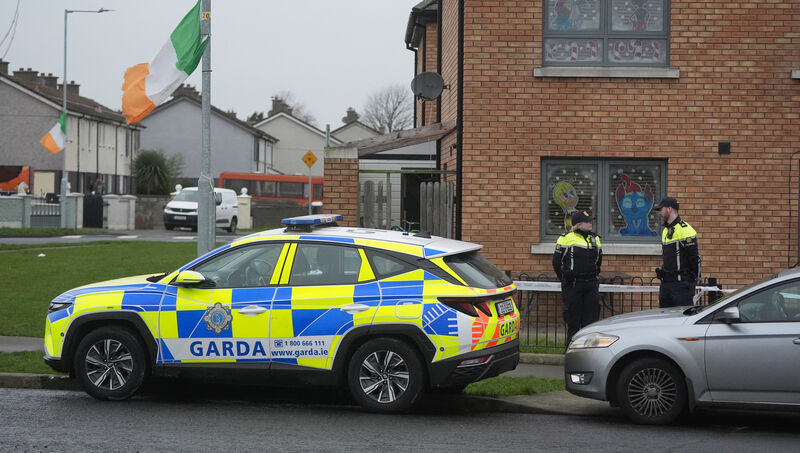 Members of An Garda outside a property in the Cherry Orchard area of Ballyfermot, west Dublin, where the body of a man in his 40s was found. Picture: PA