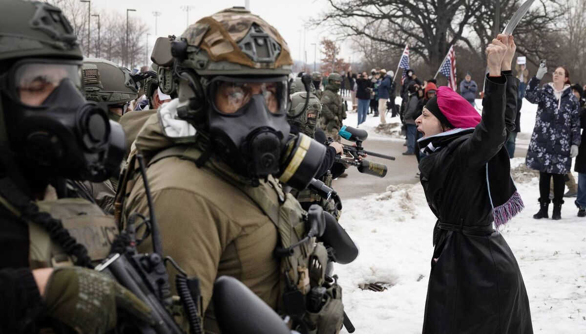 Demonstrators confront federal agents outside the Whipple federal building in Minneapolis, Minnesota, yesterday, after an ICE agent fatally shot a woman. Picture: Scott Olson/Getty
                    