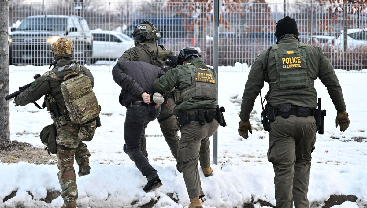 One protester is removed by federal agents as tensions rise across Minneapolis.  Picture: Tom Baker/AP
                    