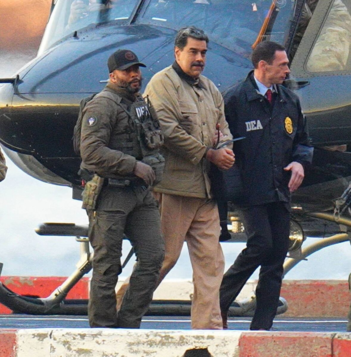 Nicolas Maduro is seen in handcuffs after landing at a Manhattan helipad, escorted by heavily armed Federal agents as they make their way into an armored car en route to a Federal courthouse in Manhattan on January 5, 2026 in New York City. (Photo by XNY/Star Max/GC Images)