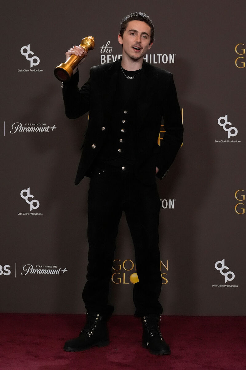 Timothée Chalamet poses with the award for best performance by a male actor in a motion picture – musical or comedy for Marty Supreme. Picture: AP/Chris Pizzello.