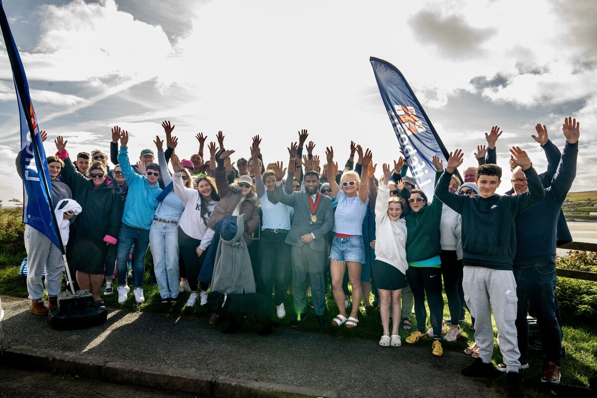 Well-wishers and swimmers gather above Inchydoney Beach to cheer on the Sea Fillies as they finish their final swim in support of the RNLI. 