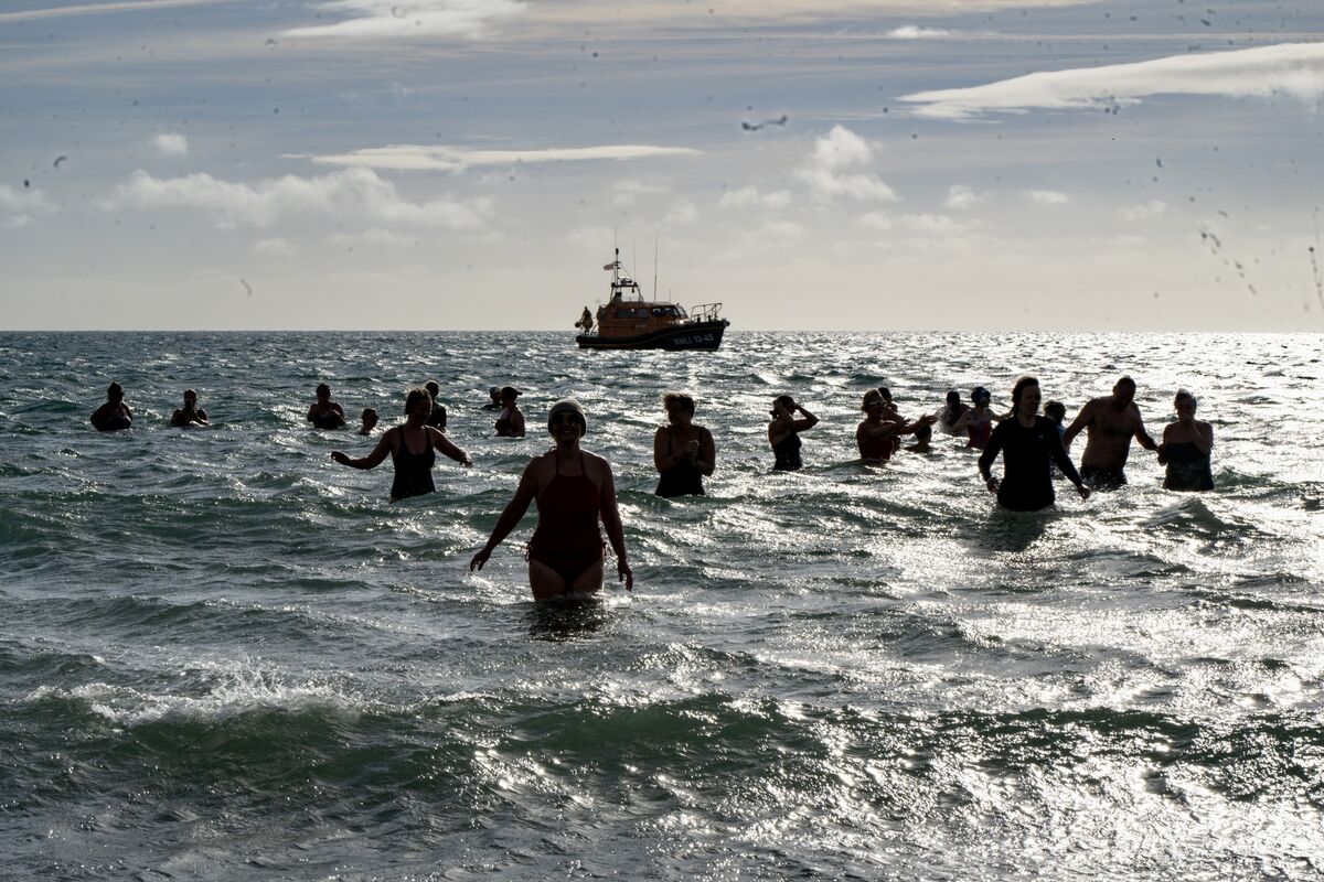 Silhouetted against the bright October sun, swimmers take to the waves at Inchydoney Beach to join Orla Leahy and Biddy Hughes for their final Sea Fillies swim in aid of the RNLI. 