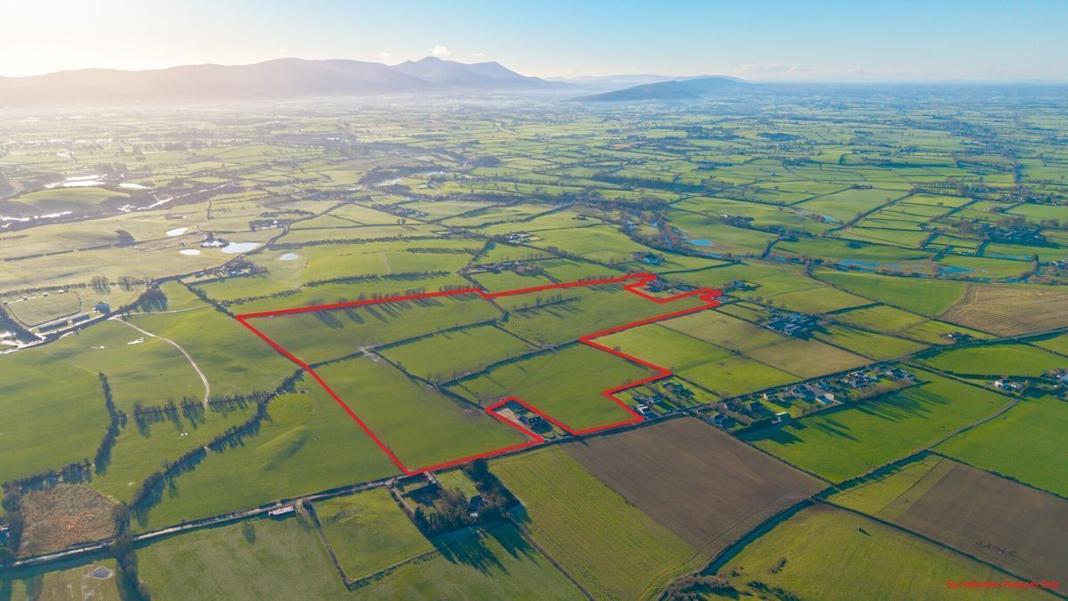 View of 70-acre Cloghleigh Golden farm with Knockmealdowns in background.