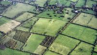 An aerial view of the rural landscape around Dublin Airport , Ireland, showing a patchwork of green fields divided by hedgerows