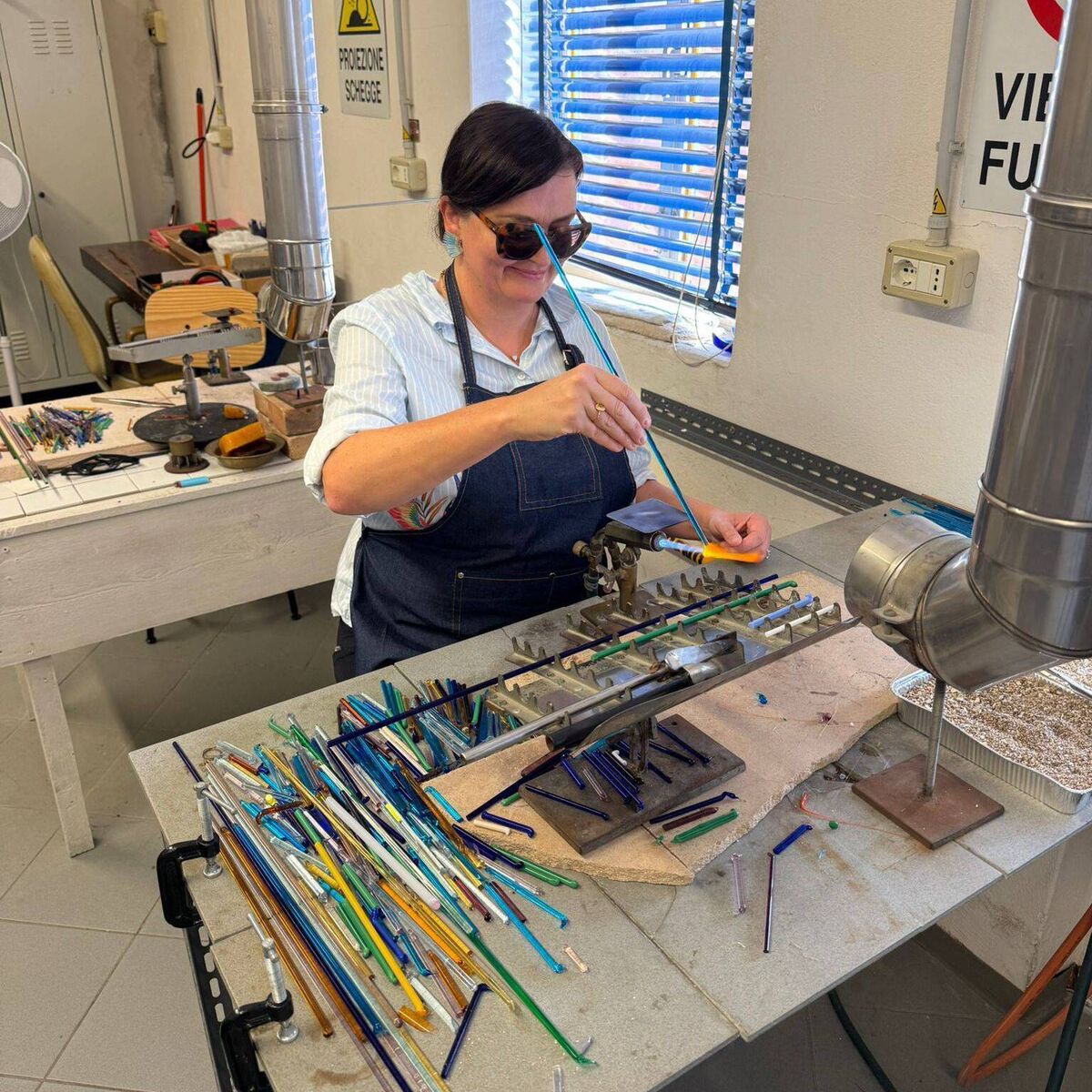 Esther McCarthy making Murano glass beads in Venice.
