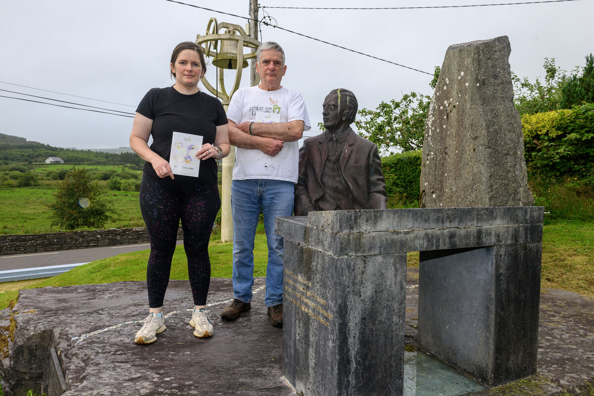 Peadar Ó Riada and his daughter Ruth standing next to the a statue of Seán Ó Riada in Séipéal Ghobnatan, Cúil Aodha. Picture: Dan Linehan
