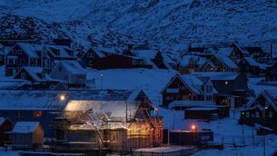 People walk along a street in Nuuk, Greenland (Evgeniy Maloletka/AP)