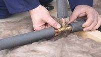 Plumber connecting copper water pipes.
