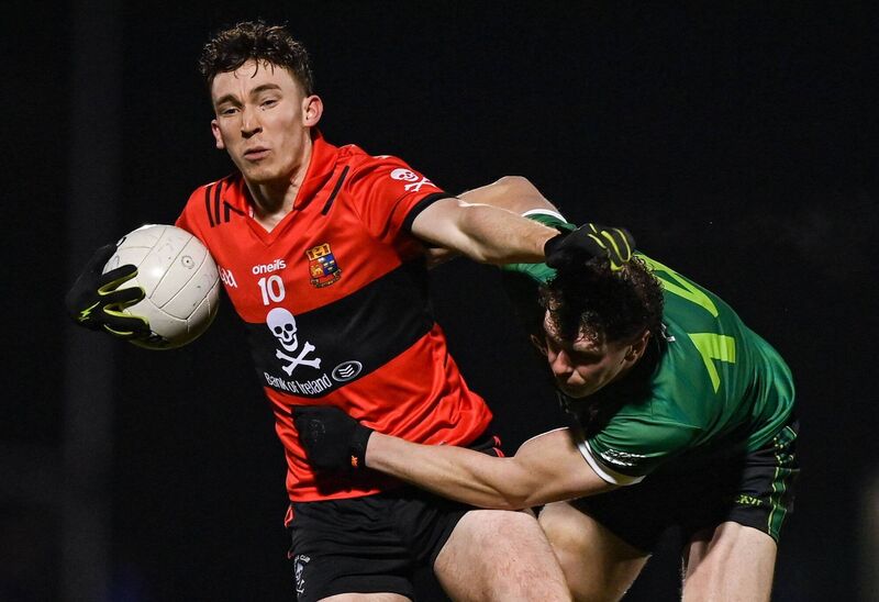 Ruairi Murphy of UCC holds off Michael Burnett at the GAA National Games Development Centre in Abbotstown. Picture: Tyler Miller/Sportsfile