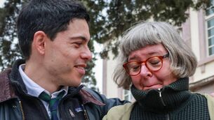 <p>Defendant Sean Binder stands with his mother outside the court of Mytilene in the island of Lesbos on November 18, 2021</p>