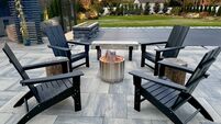Outdoor sitting area fire pit in a chilly New York backyard in the fall. Enjoy landscaping, foliage and beauty while staying war