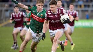 <p>Brian Cogger of Galway and John MacMonagle of Mayo in full flight. Pic: INPHO/Andrew Paton</p>