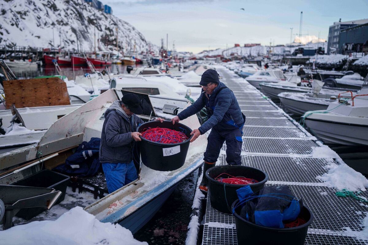 Life goes on for Greenlandic fishermen working in the harbor of Nuuk amid the furore precipitated by US president Donald Trump. 	Picture: Evgeniy Maloletka/AP
