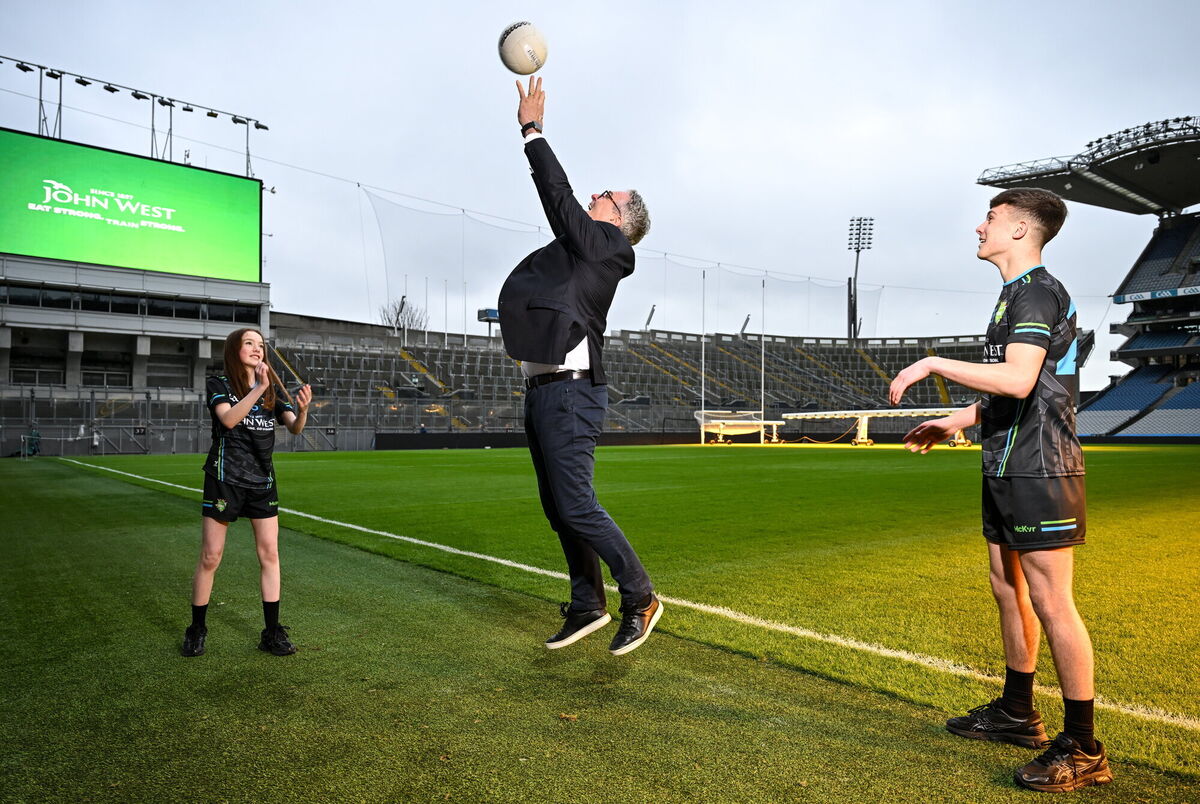 Uachtarán Chumann Lúthchleas Gael Jarlath Burns, centre, with Isabelle O’Meara and Cillian O’Hanlon of O’Tooles GAA Club. Pic: Sam Barnes/Sportsfile