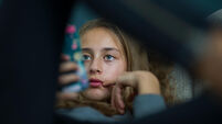 Young girl relax with her smartphone on a sofa