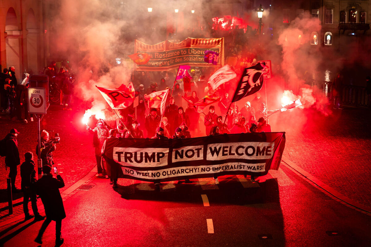 Protesters hold a banner reading "Trump not welcome" during a rally against the World Economic Forum in Davos and the visit of US President Donald Trump, in Zurich, Switzerland, on Monday, Jan. 19, 2026. (Michael Buholzer/Keystone via AP)