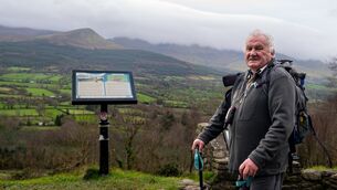 <p>Veteran walker and local historian Mike Moroney takes in sweeping views of the Galtee Mountains from the Glen of Aherlow in Co Tipperary. Picture Chani Anderson</p>