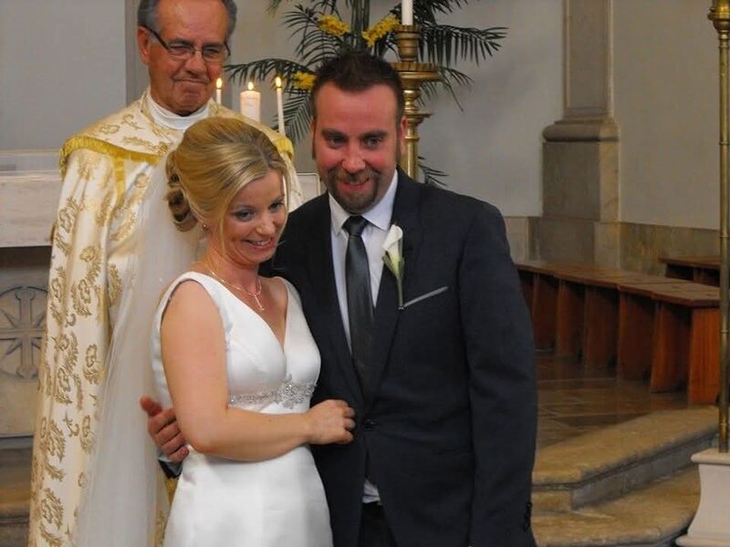 Sharon and Danny with the priest who married them.
