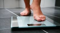 Female bare feet with weight scale