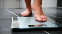 Female bare feet with weight scale