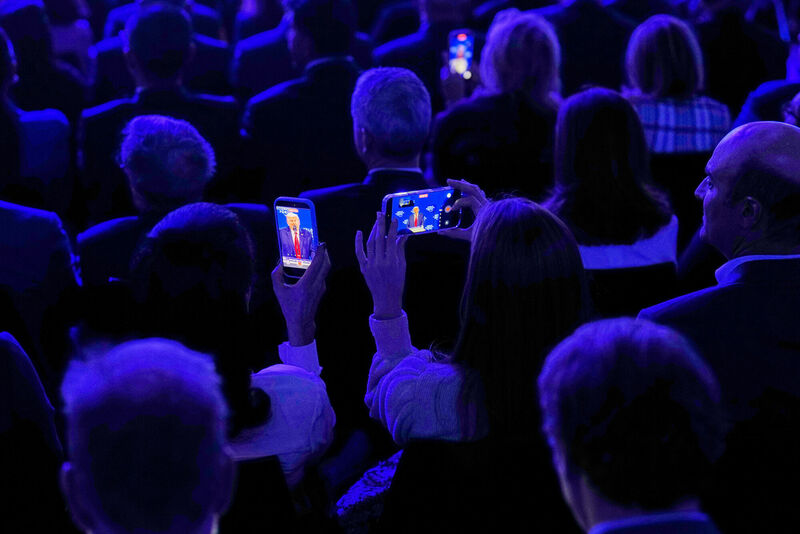People film President Donald Trump during his speech at the World Economic Forum in Davos, Switzerland, Wednesday, Jan. 21, 2026. (AP Photo/Markus Schreiber) People film President Donald Trump during his speech at the World Economic Forum in Davos, Switzerland, Wednesday, Jan. 21, 2026. (AP Photo/Markus Schreiber)