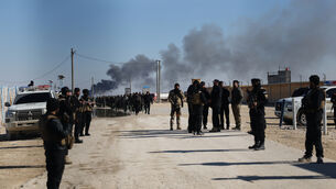Syrian government forces patrol inside the al-Hol camp in Syria (Ghaith Alsayed/AP)
