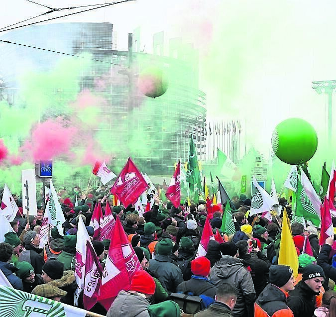 Farmers wave banners and set off flares during a demonstration against the EU-Mercusor trade agreement outside the European Parliament in Strasbourg. Picture: Pascal Bastien/AP Farmers wave banners and set off flares during a demonstration against the EU-Mercusor trade agreement outside the European Parliament in Strasbourg. Picture: Pascal Bastien/AP