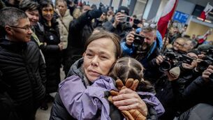 <p>Greenland's foreign minister Vivian Motzfeldt hugs her grandchild after she lands at the airport in Greenland's capital Nuuk on Tuesday. Greenland is not a game. It is a country made up of people. Photo: Mads Claus Rasmussen / Ritzau Scanpix / AFP via Getty Images</p>