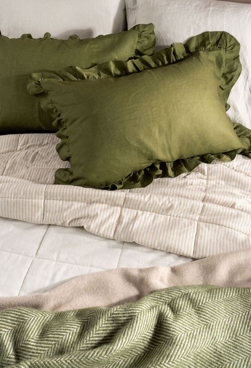  For a contemporary take on ruffled linens, add a cushion selection to decorate bed linen in trending olive green; €49, Soak &amp; Sleep.
