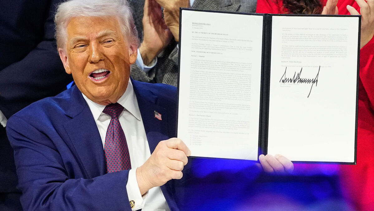 Donald Trump holds the charter at a signing ceremony on his board of peace initiative at the World Economic Forum in Davos, Switzerland. 	Picture: Markus Schreiber/AP