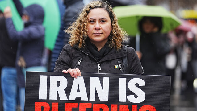 <p>Organiser Roshin Farahani taking part in a protest on O’Connell Street in Dublin. Picture: Brian Lawless/PA</p>