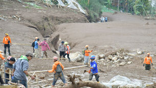 Rrescuers search for victims in Pasir Langu village (BASARNAS via AP)
