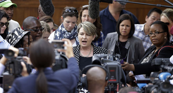 Anneliese Burgess, a spokesperson for Oscar Pistroius family, reads a statement outside the house of Pistorius' uncle in Pretoria, South Africa, today. Pic: AP Anneliese Burgess, a spokesperson for Oscar Pistroius family, reads a statement outside the house of Pistorius' uncle in Pretoria, South Africa, today. Pic: AP