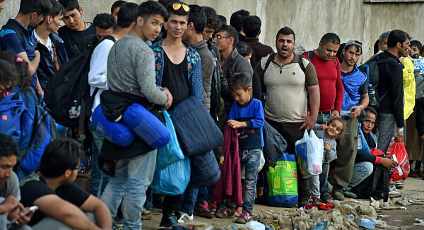 Some of the migrants and refugees, estimated as more than 20,000 daily, from Syria, Aghanistan and Iraq, who have crossed the border from Macedonia to Serbia, wait in Miratovac for transport to a refugee centre in Presevo. Pic: PA Some of the migrants and refugees, estimated as more than 20,000 daily, from Syria, Aghanistan and Iraq, who have crossed the border from Macedonia to Serbia, wait in Miratovac for transport to a refugee centre in Presevo. Pic: PA