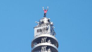 <p>US rock climber Alex Honnold raises his arms from the top of the Taipei 101 building after he successfully free soloed the landmark skyscraper without ropes or safety gear in Taipei on Sunday. Picture: I-Hwa Cheng/Getty Images</p>