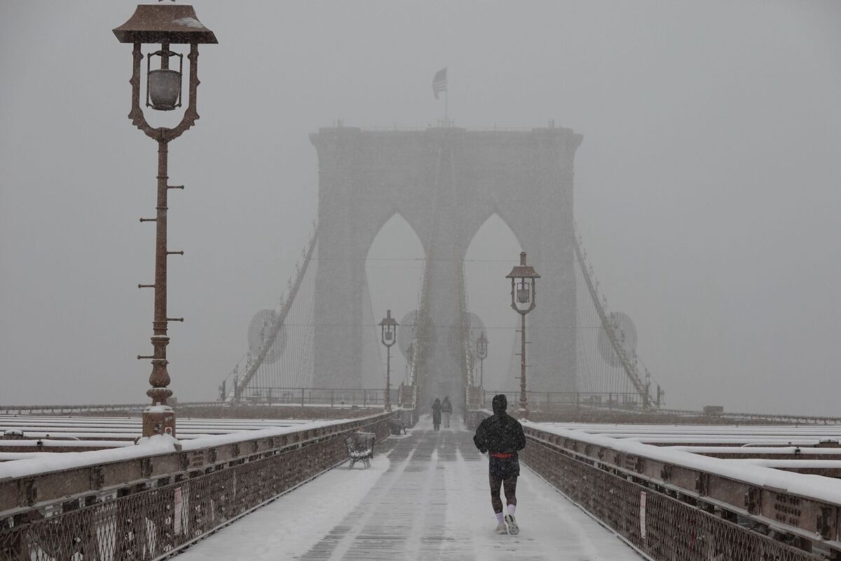 A person jogs across the Brooklyn Bridge as it snows on Sunday, Jan. 25, 2026, in New York. (AP Photo/Alyssa Goodman) A person jogs across the Brooklyn Bridge as it snows on Sunday, Jan. 25, 2026, in New York. (AP Photo/Alyssa Goodman)