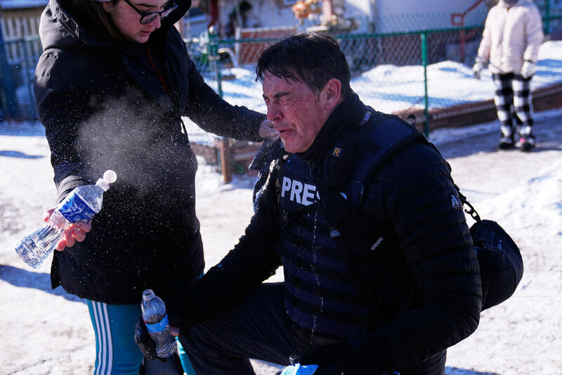 Photographer John Autey receives medical attention in Minneapolis. Picture: Abbie Parr/AP Photographer John Autey receives medical attention in Minneapolis. Picture: Abbie Parr/AP